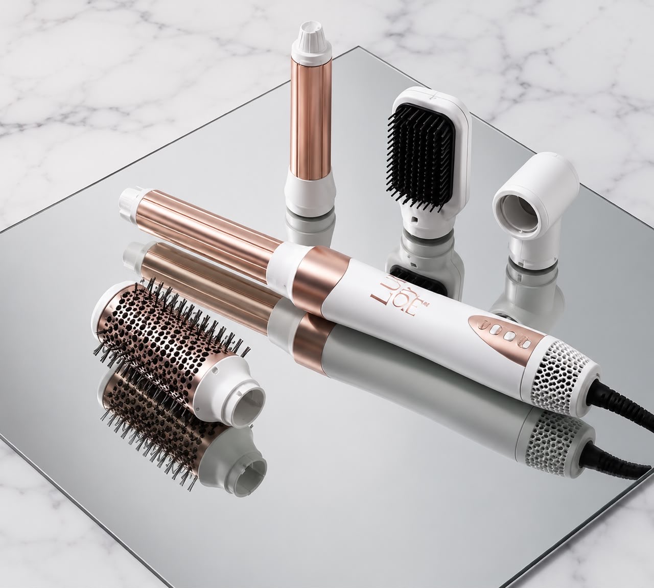 The LBY styler and its five attachments arranged on a mirrored surface